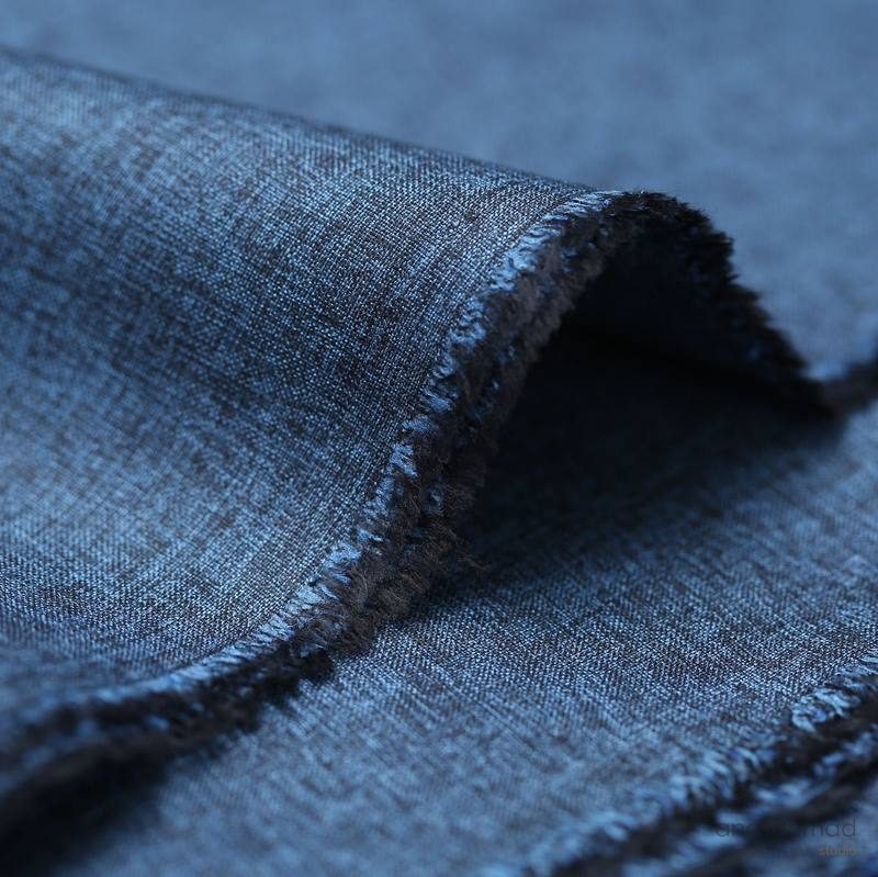 Navy melange fabric fold with frayed edge, macro texture detail