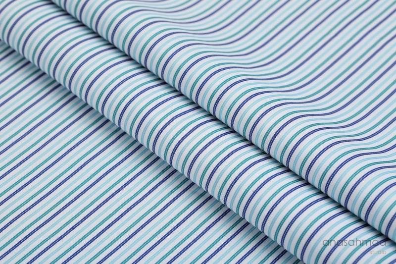 Teal and navy striped shirting fabric, rolled macro detail