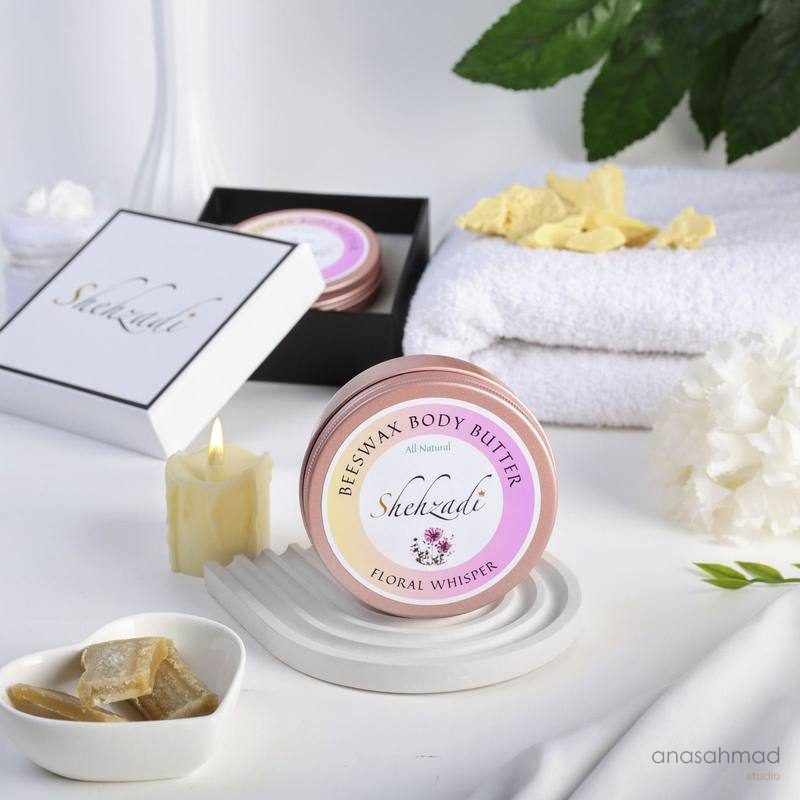 Shehzadi Beeswax Body Butter in Floral Whisper, styled with white towels and candle
