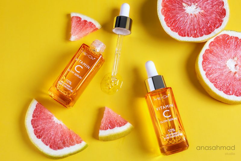 Meon Vitamin C glow serum bottles with fresh grapefruit slices — Anas Ahmad Studio, Karachi