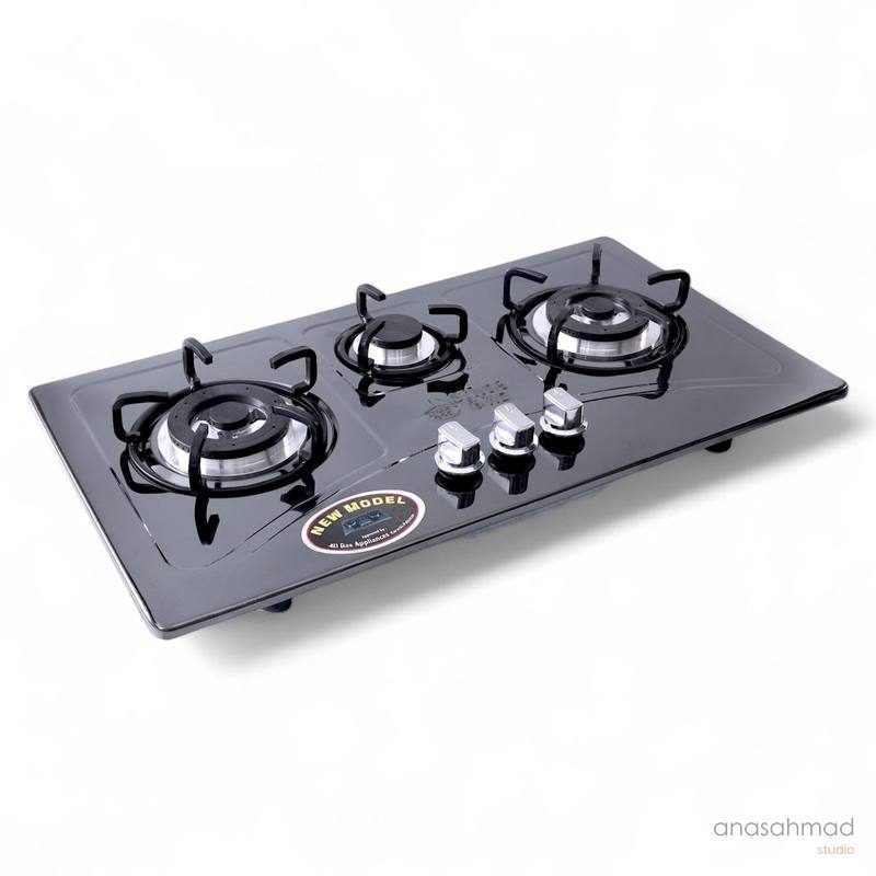 Black glass-top three-burner gas stove with chrome knobs