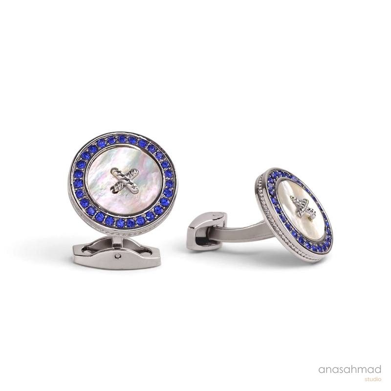 Silver cufflinks with blue crystal border and mother-of-pearl button design