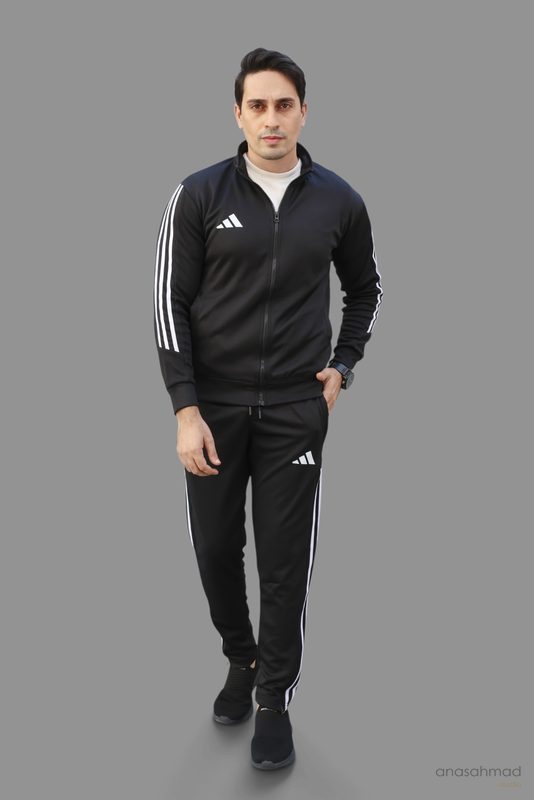 Male model in black tracksuit, studio shot, walking pose