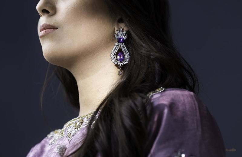 Amethyst and diamond drop earring on model, close-up profile shot