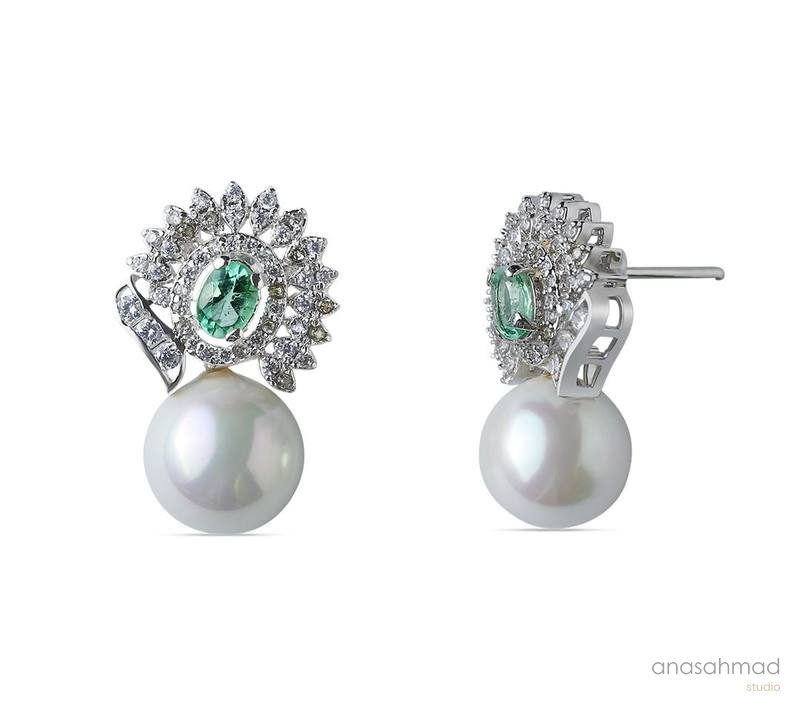 Emerald and pearl drop earrings shown from front and side angles