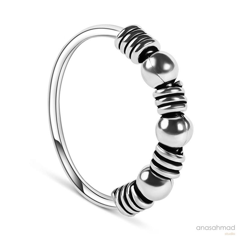 Sterling silver beaded ring on white background