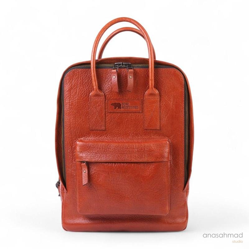 Bear Necessities cognac leather backpack with embossed logo patch