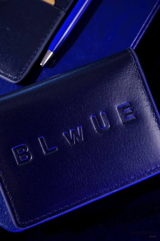BLWUE embossed leather goods styled with dramatic blue lighting
