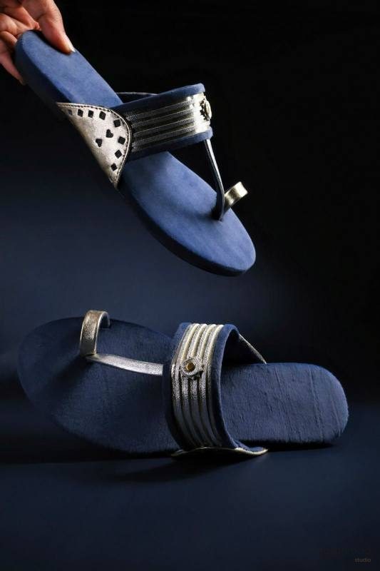 Navy velvet and gold leather sandals, dramatic studio lighting