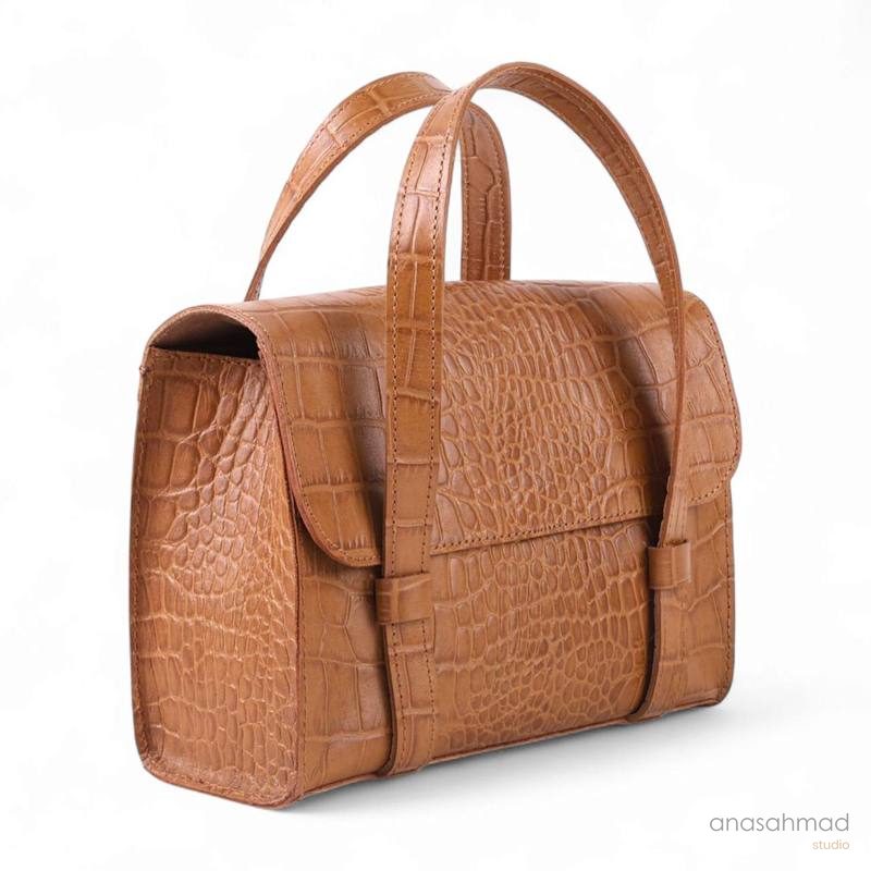 Tan croc-embossed leather handbag with double handles, side angle