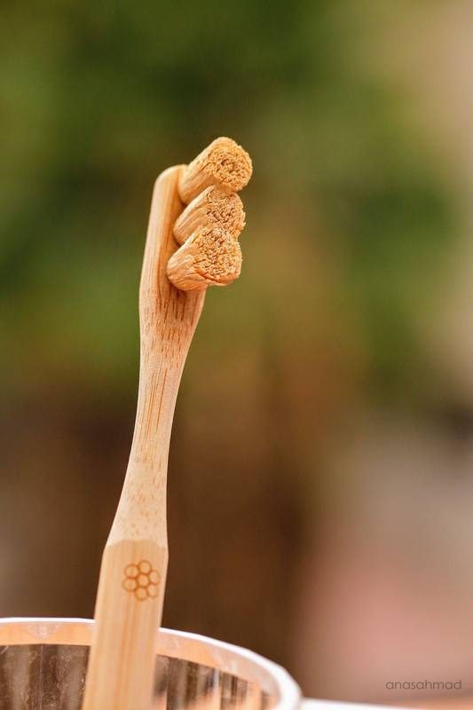 Bamboo toothbrush macro detail with natural bokeh background