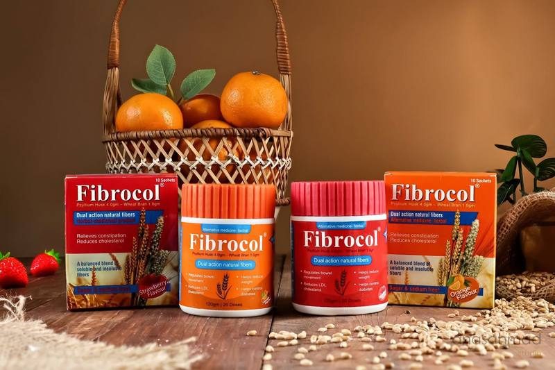 Fibrocol fiber supplement full range, boxes and jars, styled with oranges and strawberries
