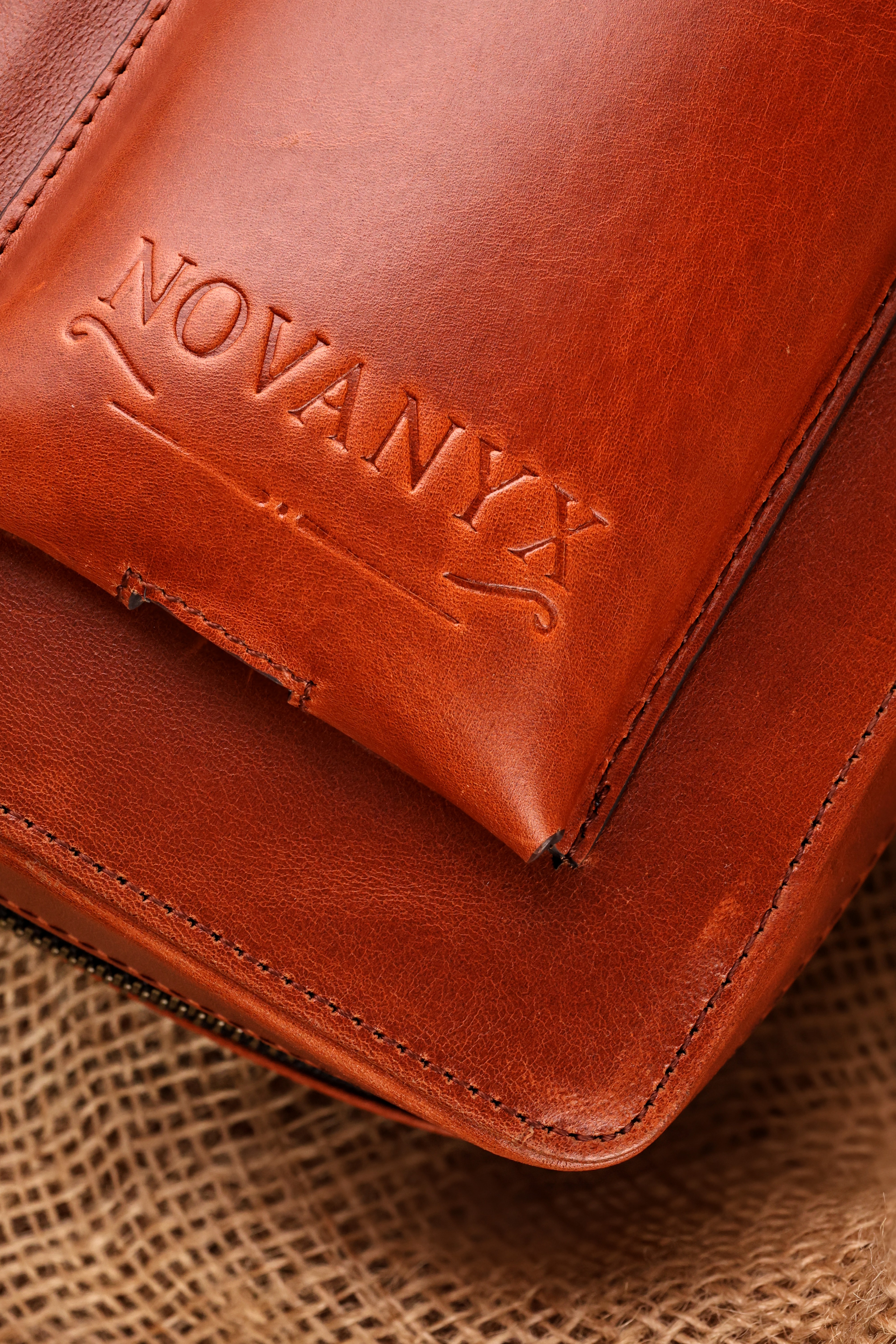 Close-up of brown leather wallet with embossed branding detail