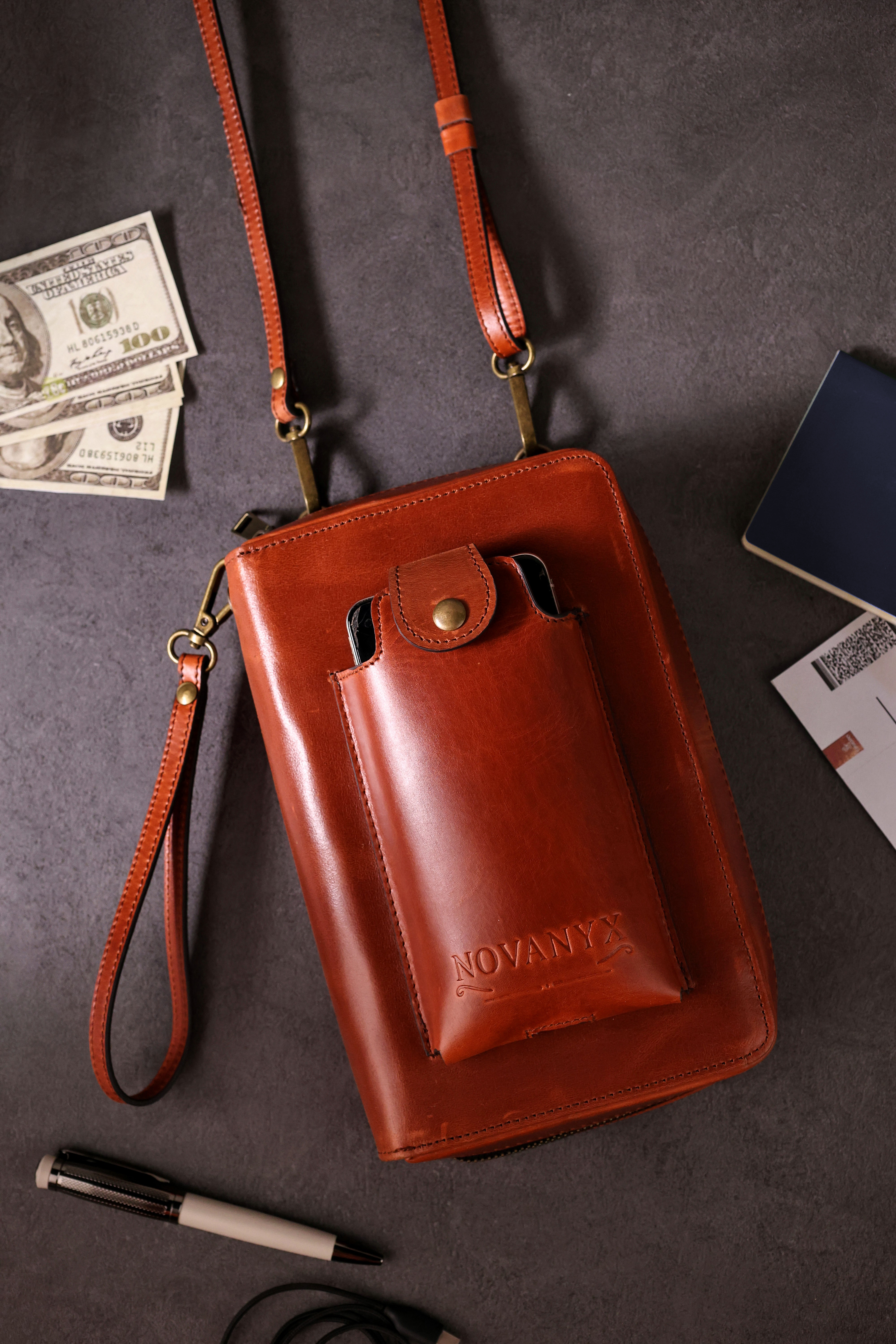 Brown leather crossbody bag with strap and everyday essentials
