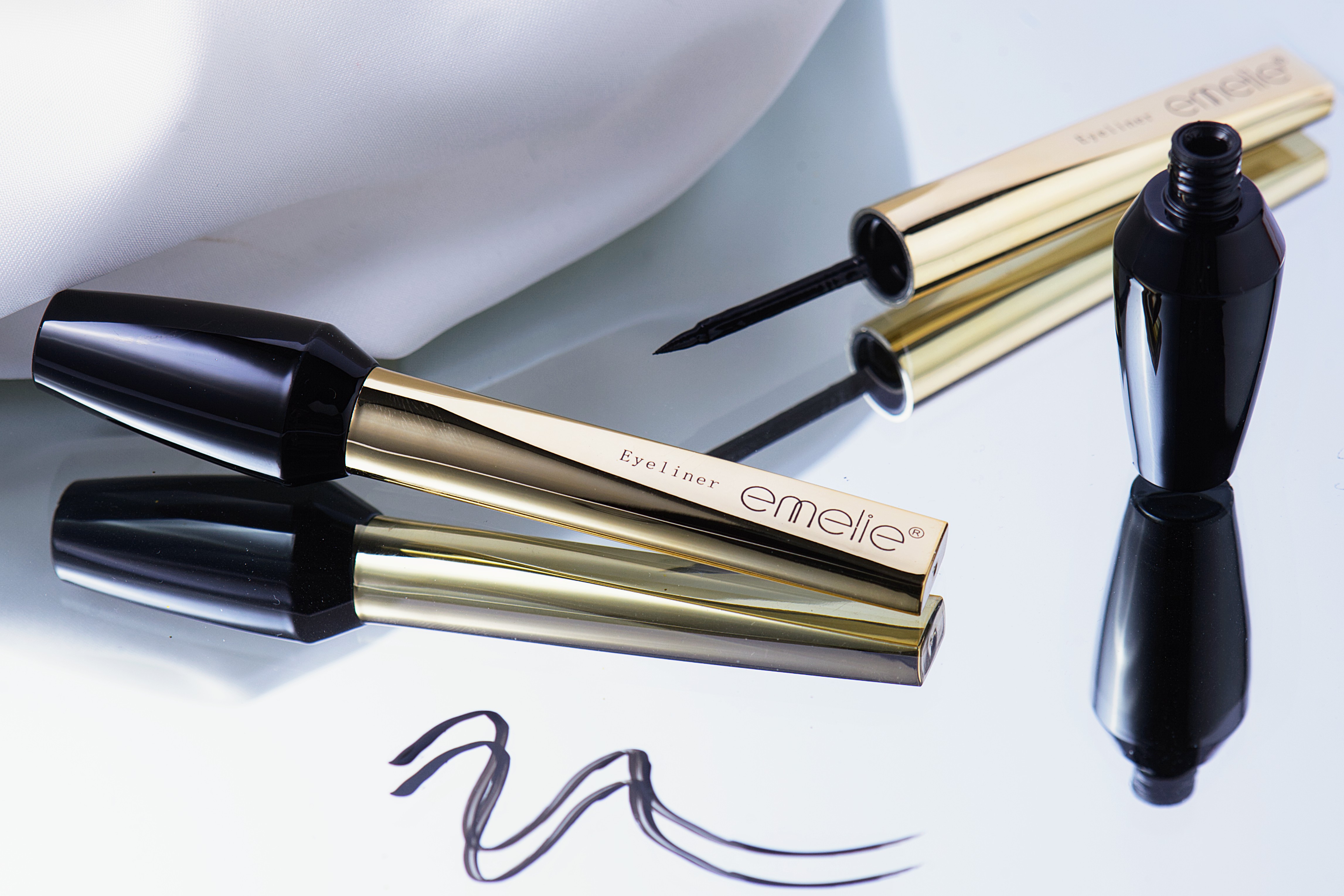 Liquid eyeliner with applicator and smooth black stroke sample